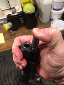 Place the plug on the end of the Recoil spring