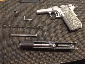 How to Disassemble a Kimber 1911- Remove the guide rod and recoil spring from the slide