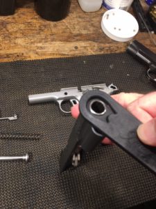 How to Disassemble a Kimber 1911- Turn the bushing counter clockwise as far as it will go