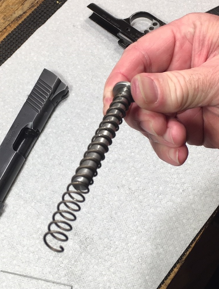 Install new spring on guide rod
