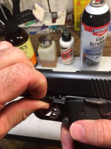 Push the Slide Lock Lever from the Opposite Side of the Gun and pull it out the Front