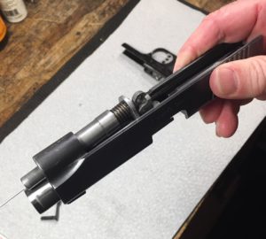Remove guide rod assembly from the slide
