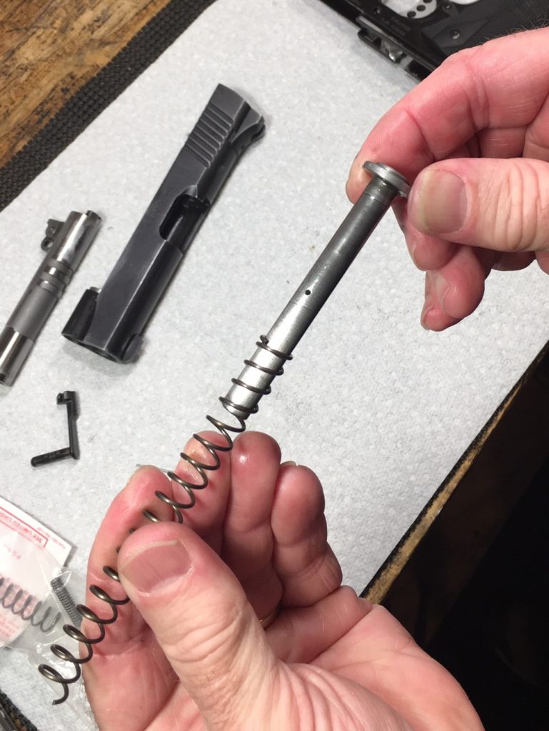 Remove the spring from the guide rod