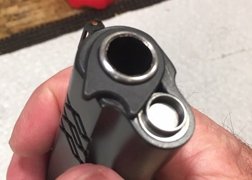 How to Reassemble a 1911-Twist the Barrel Bushing Counter Clockwise To Hold the Recoil Plug in Place