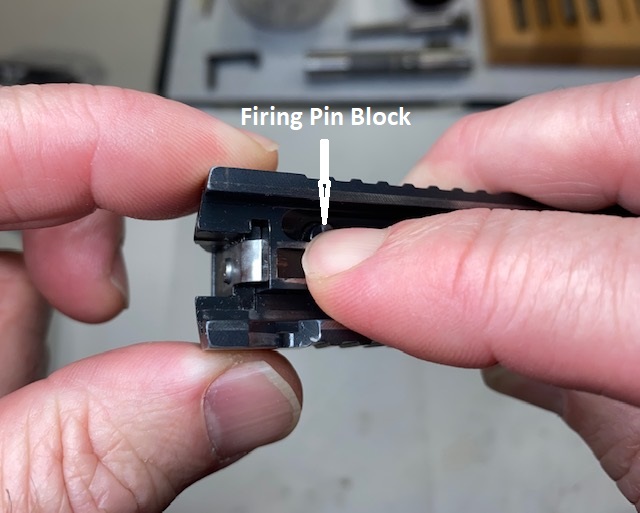Press the firing pin block