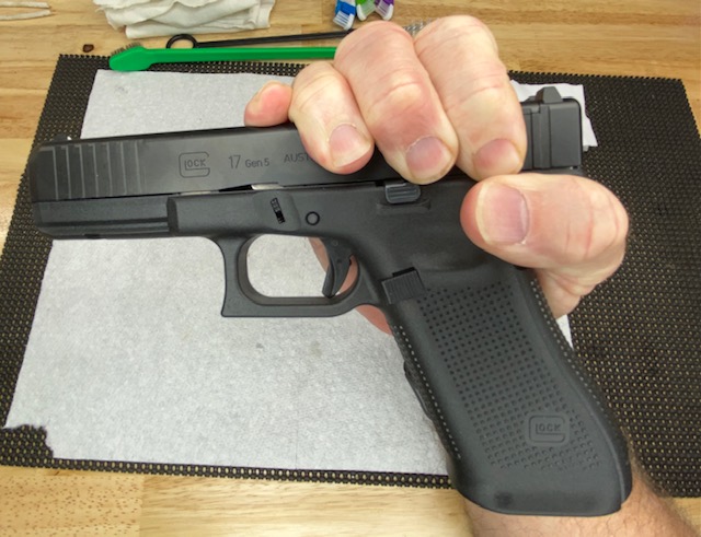 Grip the Glock as shown with your right hand
