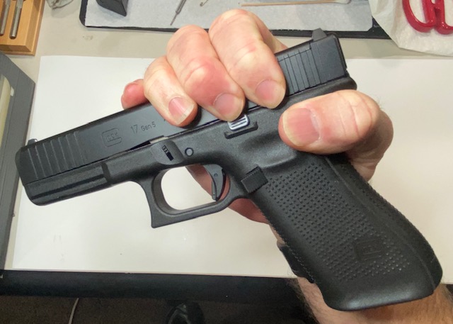 How to Field Strip & Clean a Glock 17 9mm or Glock 19 9mm Pistol: Grip the gun with right hand as pictured