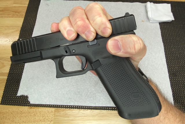 Move the Glock slide slightly to the rear