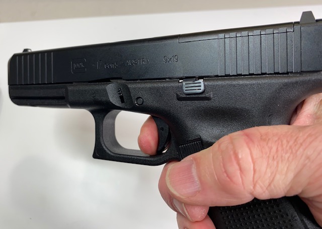 Pointed in a safe direction, press the trigger and hold it to the rear.