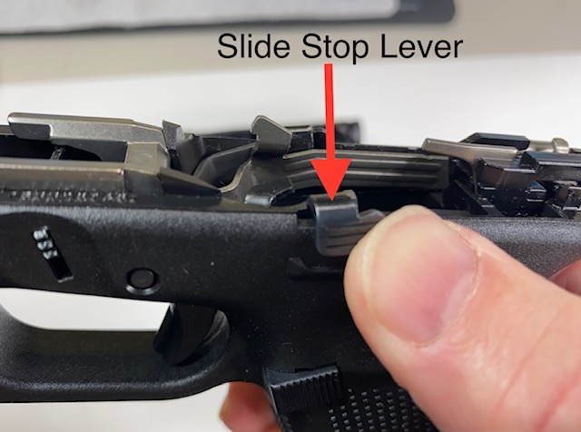Push the slide stop lever up. It should snap back down when released