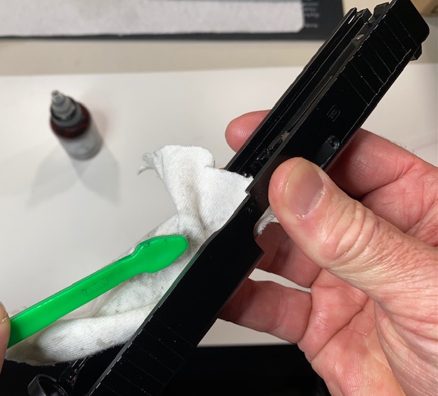 How to Field Strip & Clean a Glock 17 9mm or Glock 19 9mm Pistol: Use the gun brush to force the cloth into the slide notch and other tight places
