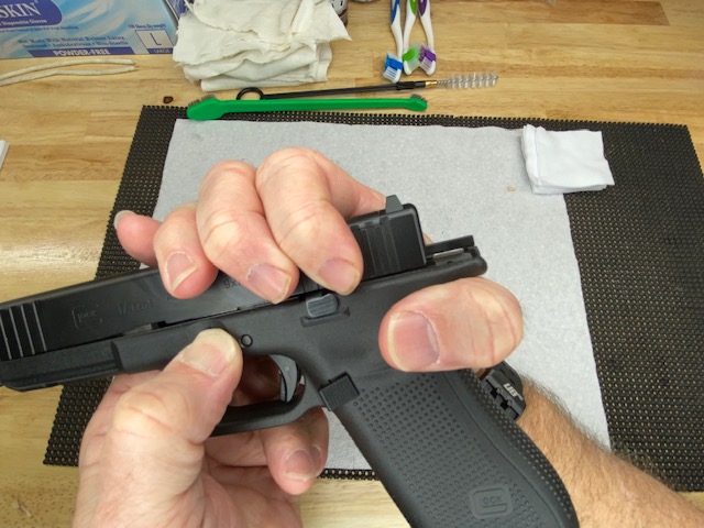 While holding the take-down levers down, move the slide forward off the front of the frame