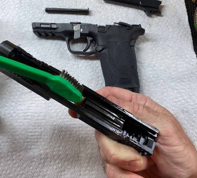 Apply Original Gun Oil or solvent to the slide and clean with soft brush