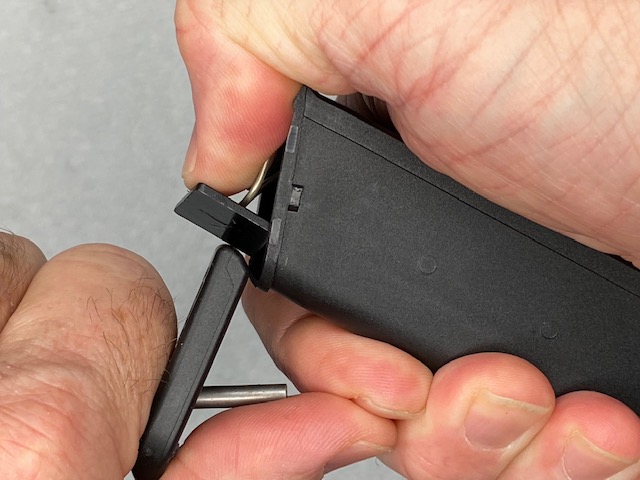 How To Remove a Glock Magazine Base Plate: Place a thumb over the end as you slide the base plate all the way off to prevent the spring form popping out