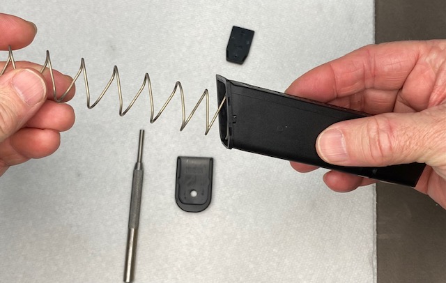 How To Remove a Glock Magazine Base Plate: Pull out the spring and follower