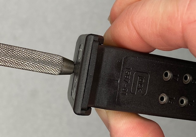 How To Remove a Glock Magazine Base Plate: Squeeze the sides with thumb & forefinger to help unlock the locking tabs