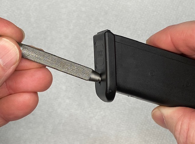 How To Remove a Glock Magazine Base Plate: The punch should be lined up as shown