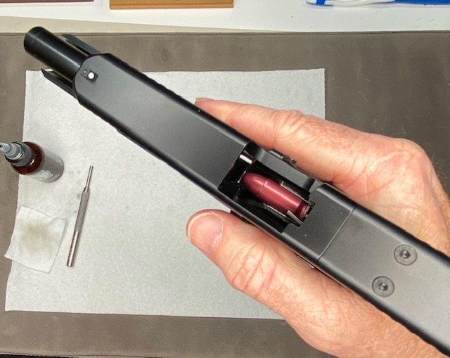 Verify that your Glock pistol is completely unloaded. Insert the dummy round magazine into the gun and rack the slide to load the first dummy round into the chamber.