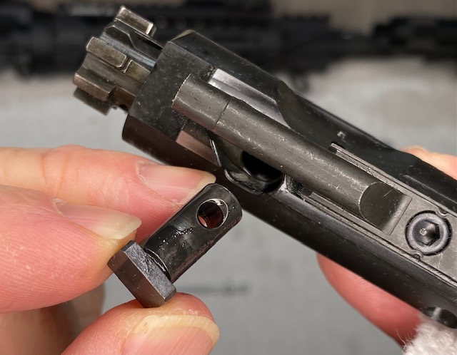How to Disassemble & Clean An AR-15 Rifle: Pull the Cam Pin all the way out of the Bolt Carrier