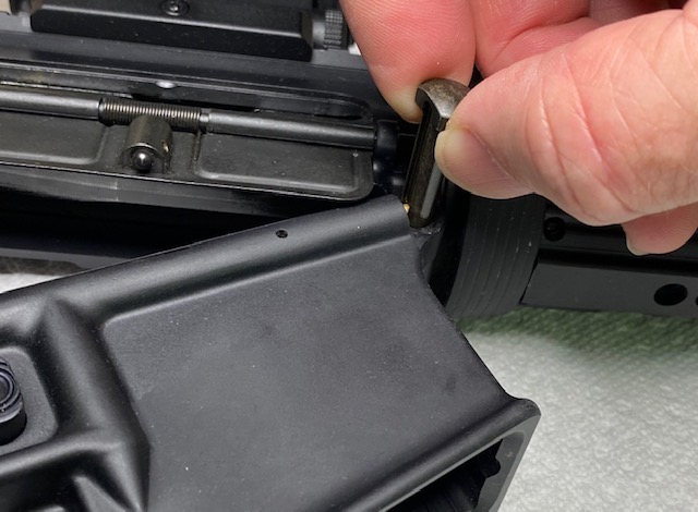 How to Disassemble & Clean An AR-15 Rifle: Pull the front takedown pin out as far as it will go