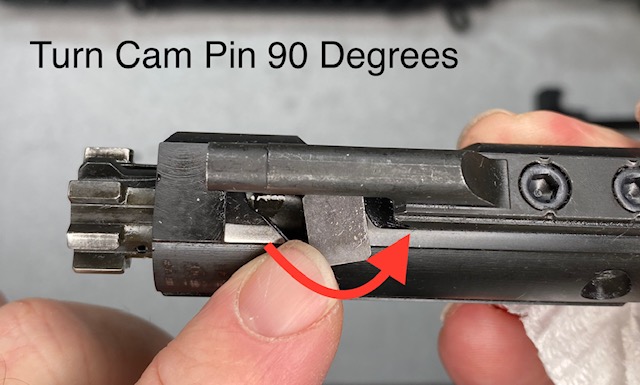 How to Disassemble & Clean An AR-15 Rifle: Twist the Cam Pin As shown