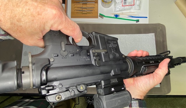 How to Disassemble & Clean An AR-15 Rifle: Verified unloaded, point the rifle in a safe direction and press the trigger