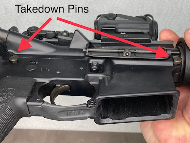 Flip the Rifle over and the Take Down Pins will be slightly raised