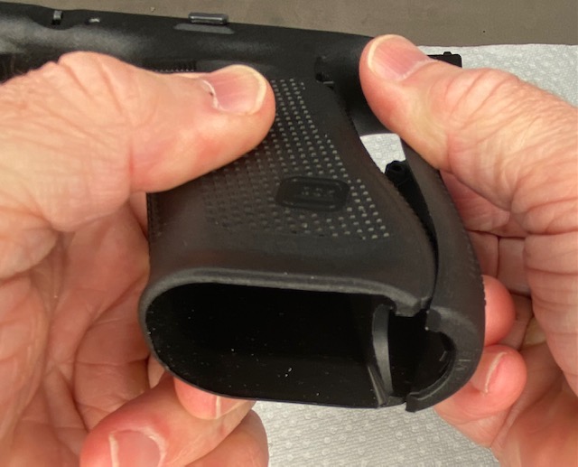 How to Install or How to Change a Glock Backstrap: Hook the bottom of the Backstrap into the bottom of the Glock grip