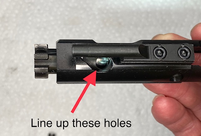 Line up the hole in the Bolt with the slot in the Carrier.