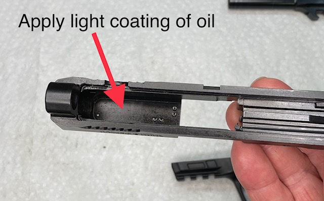 Lightly coat the inside of the slide where it rides on the barrel