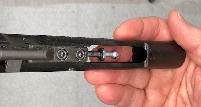 how to Disassemble an AR-16: Remove the Firing Pin by letting if fall out of the Bolt Carrier