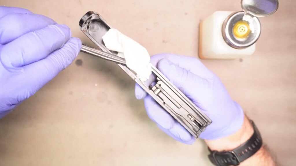 Use solvent, a gun brush, and patches to clean the Glock 19 Gen 6 slide