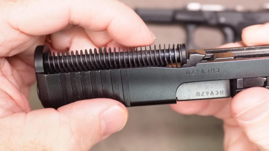 Be sure the barrel and recoil spring assembly are installed as shown