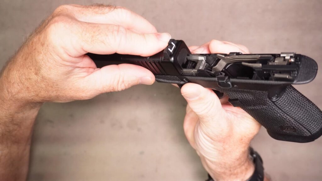 Carefully install the slide onto the frame and push it all the way back, then let it go forward to close